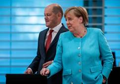 German Chancellor Angela Merkel and German Finance Minister and Vice-Chancellor Olaf Scholz arrive for...