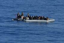 In this image provided by the Turkish Military, members of Turkish forces, left, approach migrants aboard...