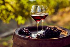 Two glasses of red wine on a wooden barrel in the