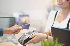 In the Cafe, Customer using credit card Makes a Pays to Woman by cashless technology System. Contact...